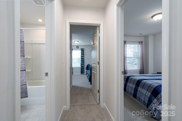 hall featuring light carpet and a wealth of natural light