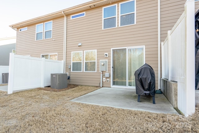 rear view of house with a patio and central air condition unit