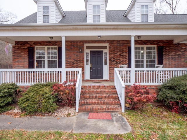 view of exterior entry featuring a porch