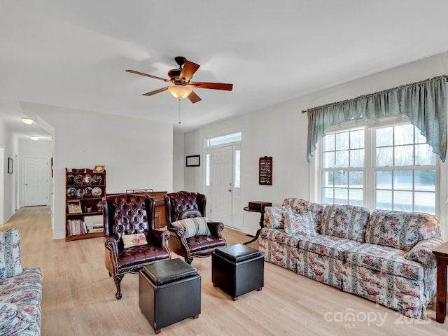 living room featuring ceiling fan and light wood-type flooring