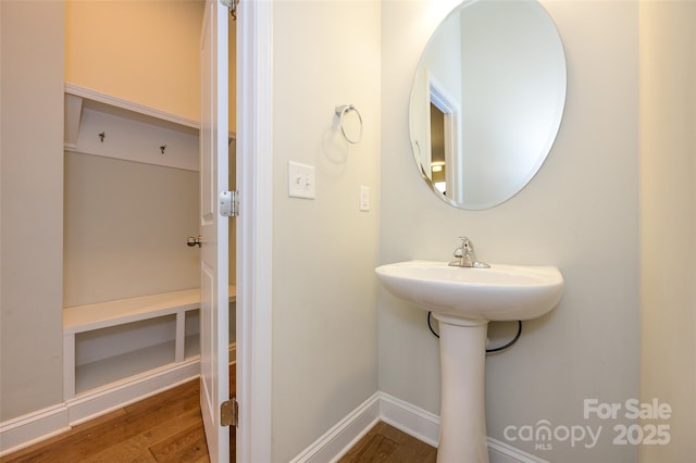 bathroom with wood finished floors and baseboards