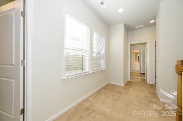 hall with light colored carpet, visible vents, baseboards, and recessed lighting