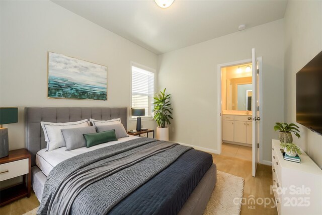 7542 Waverly Walk Ave Unit 7542, Charlotte, NC 28277 - bedroom with light wood finished floors, ensuite bathroom, and baseboards