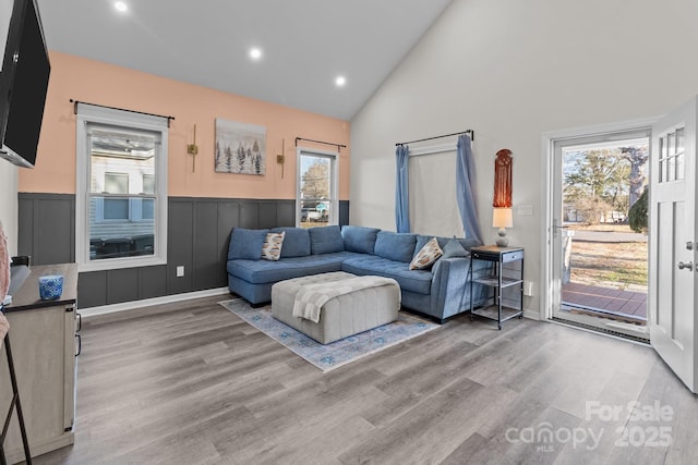 living room featuring hardwood / wood-style flooring and high vaulted ceiling