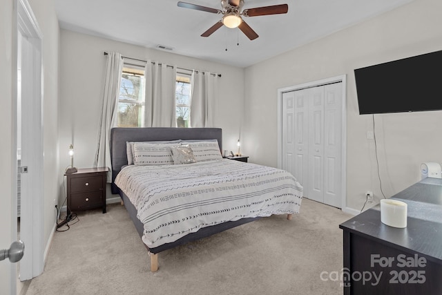 carpeted bedroom with ceiling fan and a closet