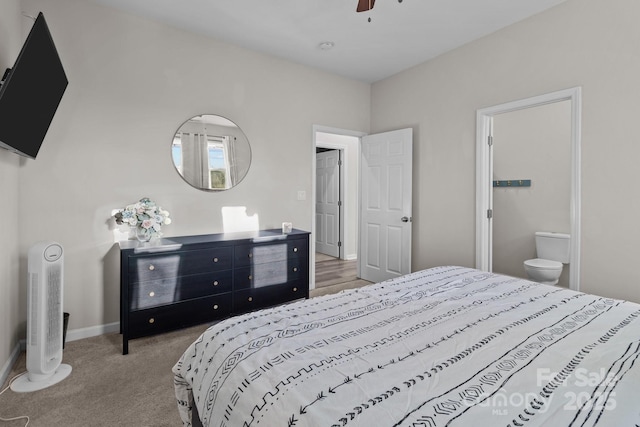 bedroom featuring carpet flooring, ensuite bathroom, and ceiling fan