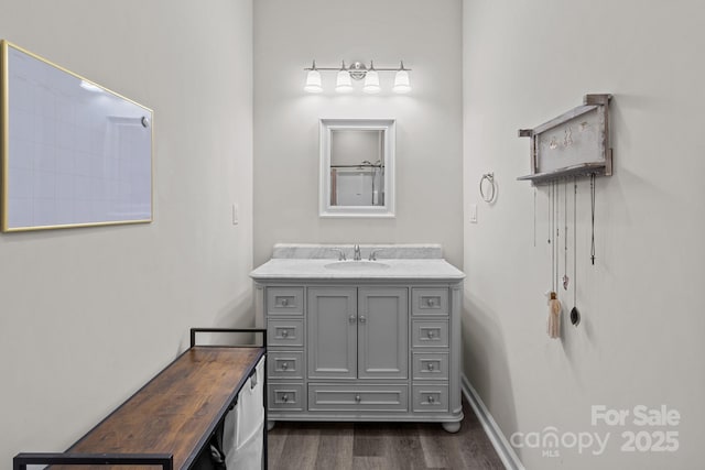 bathroom with hardwood / wood-style floors and vanity