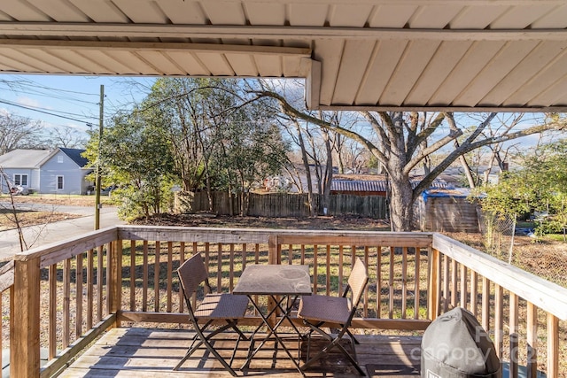 wooden deck featuring a grill