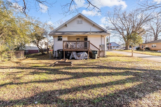 rear view of house featuring a yard