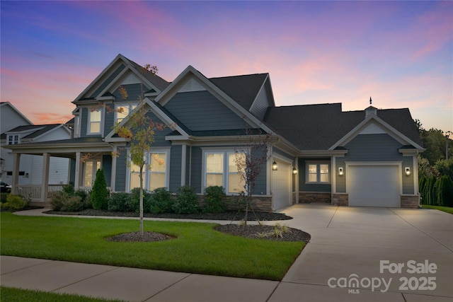 craftsman inspired home with a porch, a garage, and a yard