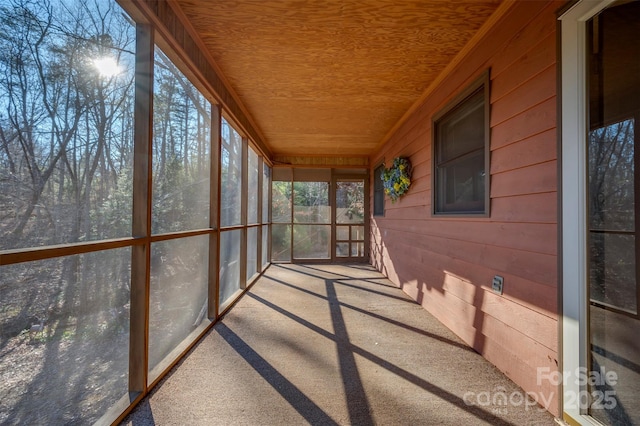 unfurnished sunroom with wood ceiling