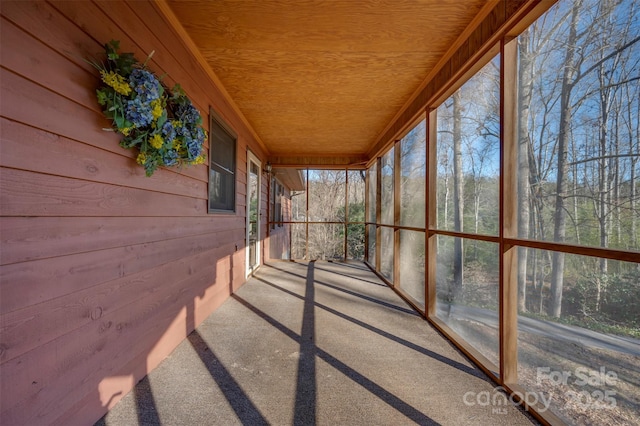 unfurnished sunroom featuring wood ceiling