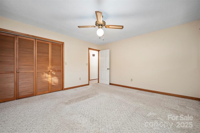 unfurnished bedroom featuring ceiling fan, a closet, and carpet