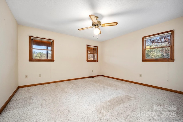 empty room with ceiling fan and carpet