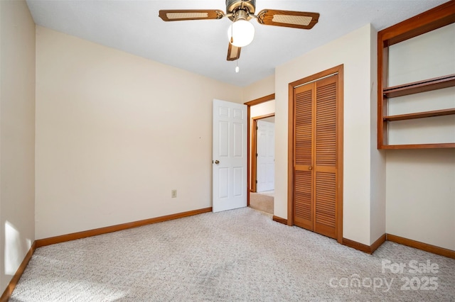 unfurnished bedroom with ceiling fan, light carpet, and a closet