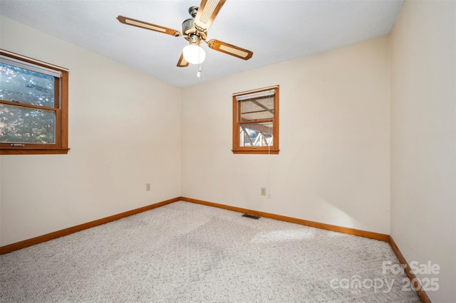 empty room with carpet flooring and ceiling fan