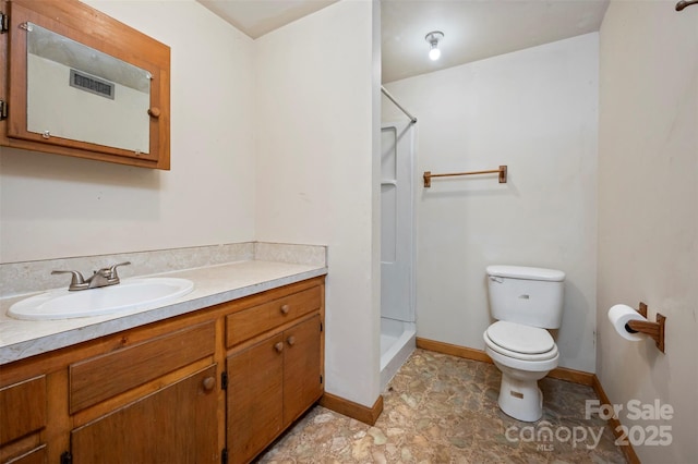 bathroom with vanity, toilet, and walk in shower