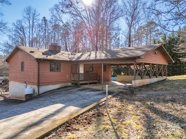 back of property featuring a carport