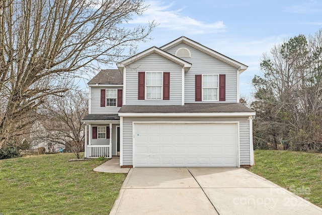 traditional-style house with driveway, a front yard, and a garage