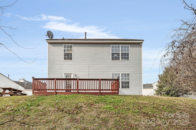 back of house featuring a yard and a wooden deck