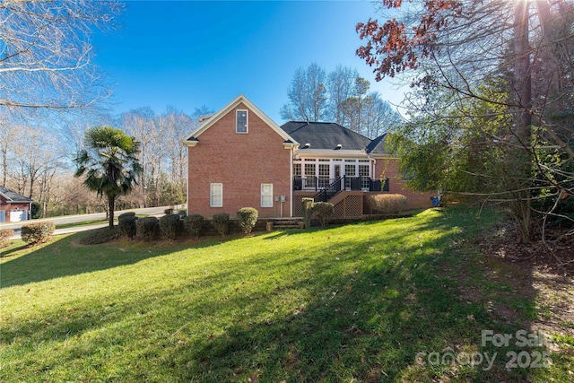 back of property featuring a yard and a deck