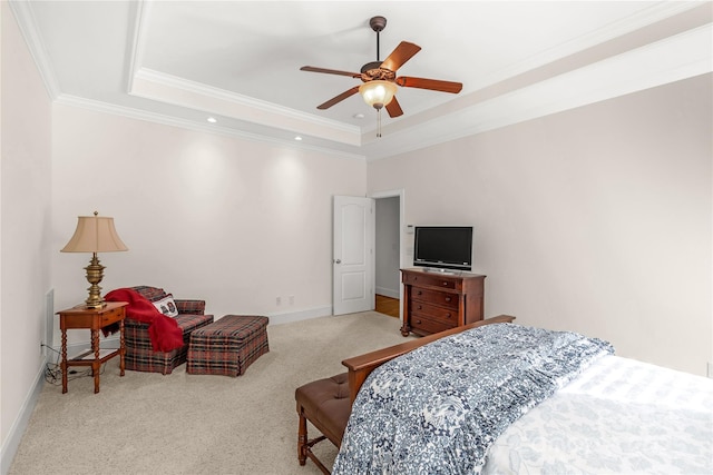 bedroom featuring a raised ceiling, ceiling fan, light colored carpet, and ornamental molding