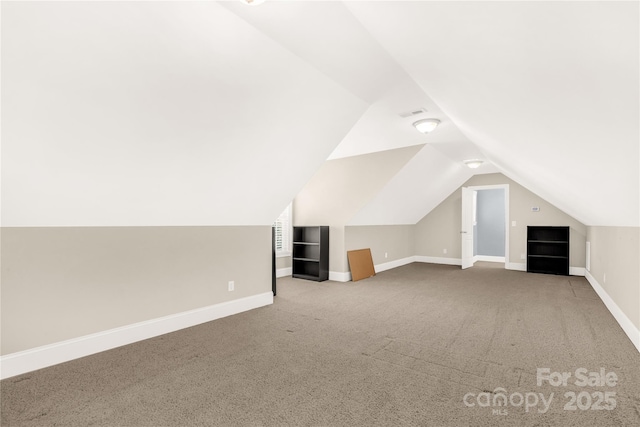 additional living space with carpet and vaulted ceiling