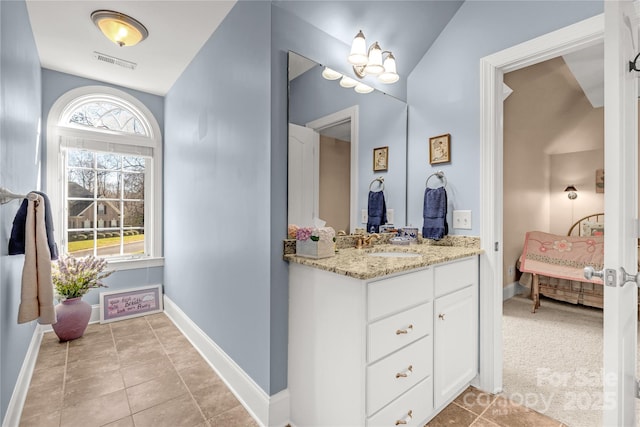 bathroom featuring tile patterned flooring, vanity, and vaulted ceiling