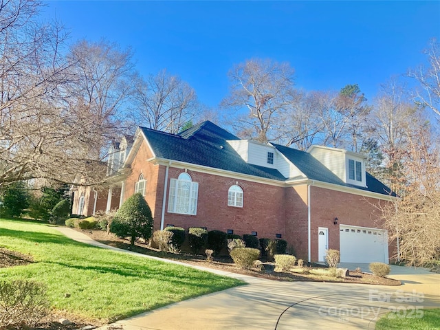 view of front of home with a front lawn and a garage