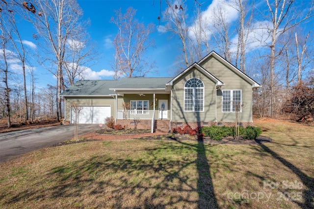 single story home with a front yard, a porch, and a garage