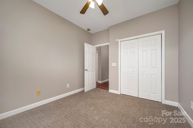 unfurnished bedroom featuring carpet, ceiling fan, and a closet