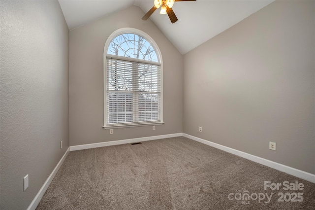 carpeted spare room with ceiling fan and lofted ceiling