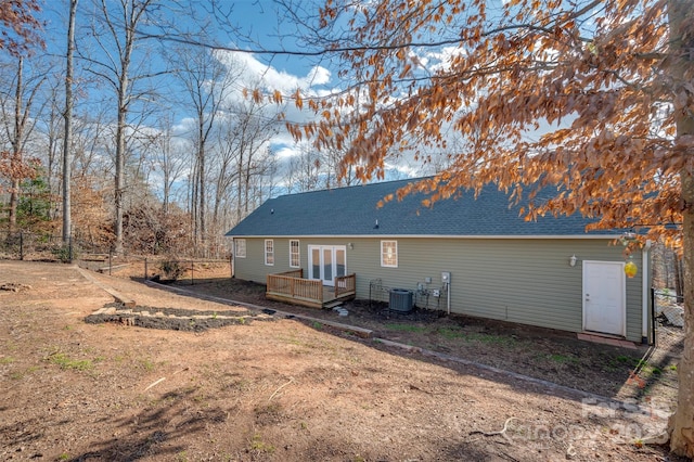 rear view of property with french doors, a deck, and cooling unit