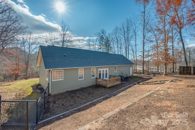 rear view of property featuring cooling unit, a wooden deck, and french doors