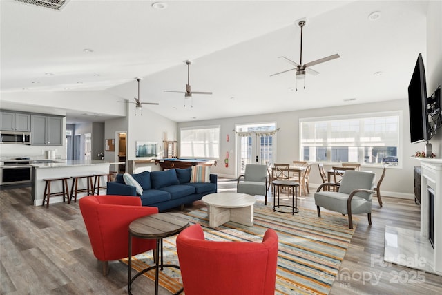 living room with dark hardwood / wood-style floors and vaulted ceiling