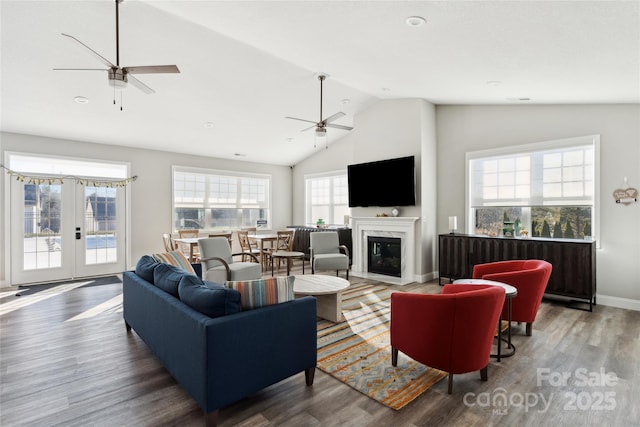 living room with a fireplace, french doors, vaulted ceiling, and dark wood-type flooring