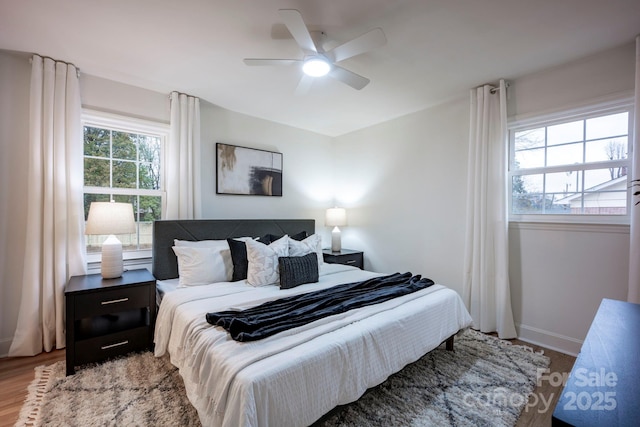 bedroom with ceiling fan and wood-type flooring