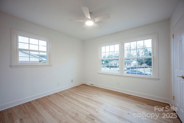 spare room featuring light hardwood / wood-style flooring and ceiling fan