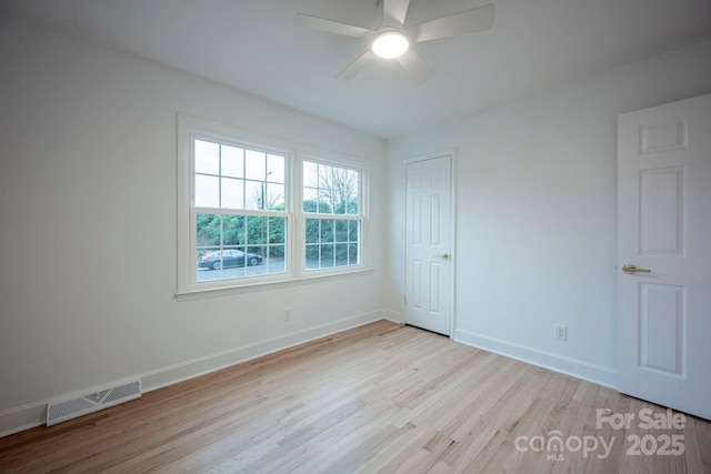 spare room featuring light hardwood / wood-style flooring and ceiling fan