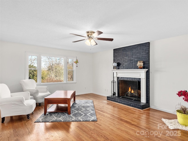 950 Blanton St, Columbus, NC 28722 - living room featuring ceiling fan, wood finished floors, and a brick fireplace