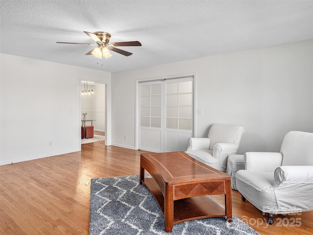 950 Blanton St, Columbus, NC 28722 - living room featuring ceiling fan, light wood-style floors, and a textured ceiling