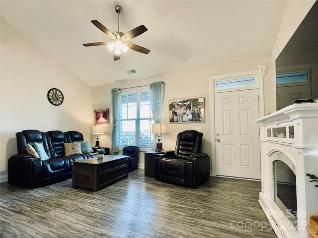 living room with dark hardwood / wood-style flooring, ceiling fan, and lofted ceiling