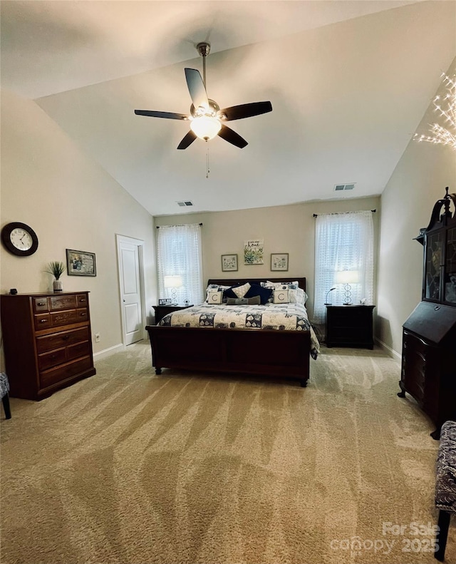 bedroom with ceiling fan, lofted ceiling, and light carpet