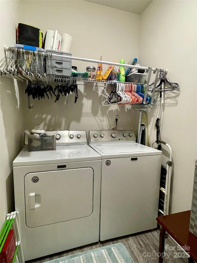 laundry room with hardwood / wood-style floors and independent washer and dryer