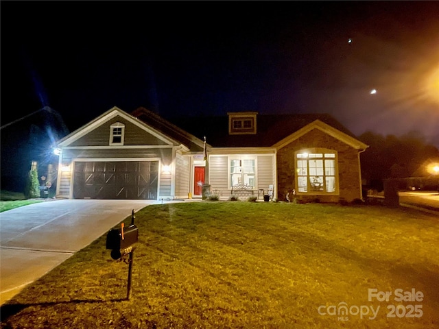 view of front of property featuring a garage and a yard