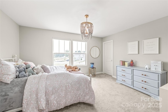 bedroom featuring a notable chandelier and light colored carpet