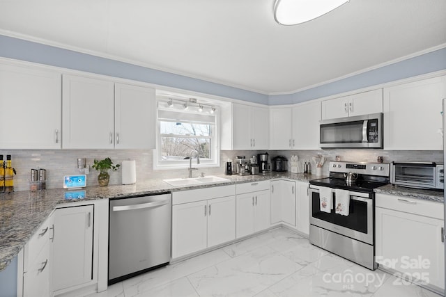 kitchen featuring stainless steel appliances, white cabinetry, and sink