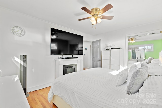 bedroom featuring light hardwood / wood-style floors and ceiling fan