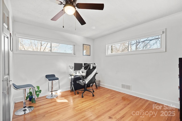 home office with hardwood / wood-style floors and ceiling fan