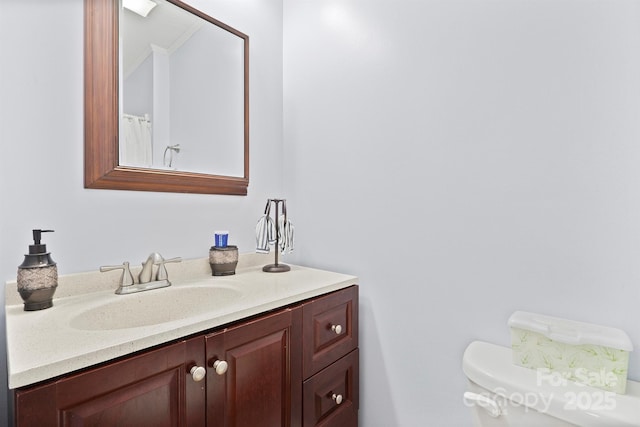 bathroom featuring vanity and toilet